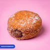 Gluten free vegan fried sugared doughnut filled with chocolate cream, the filling visible at the side