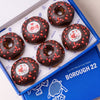 Gluten free vegan doughnuts with chocolate icing, red heart sprinkles and Love toppers in a Borough 22 box